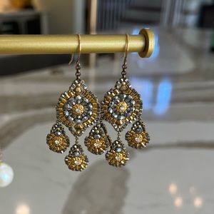 Miguel Ases gold and silver chandelier drop earrings.